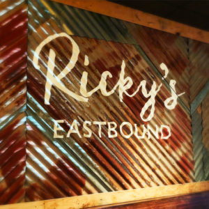 Ricky's Eastbound restaurant signage on sheet metal